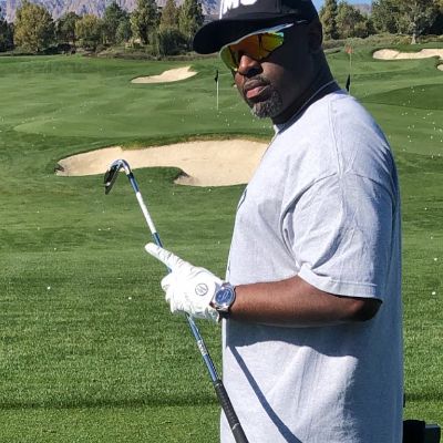 Photo of Corey Gamble holding golf stick. 
